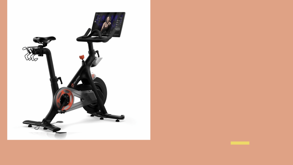 Ein vernetztes Indoor-Bike mit Bildschirm am Lenker, auf demselben orangen Grund